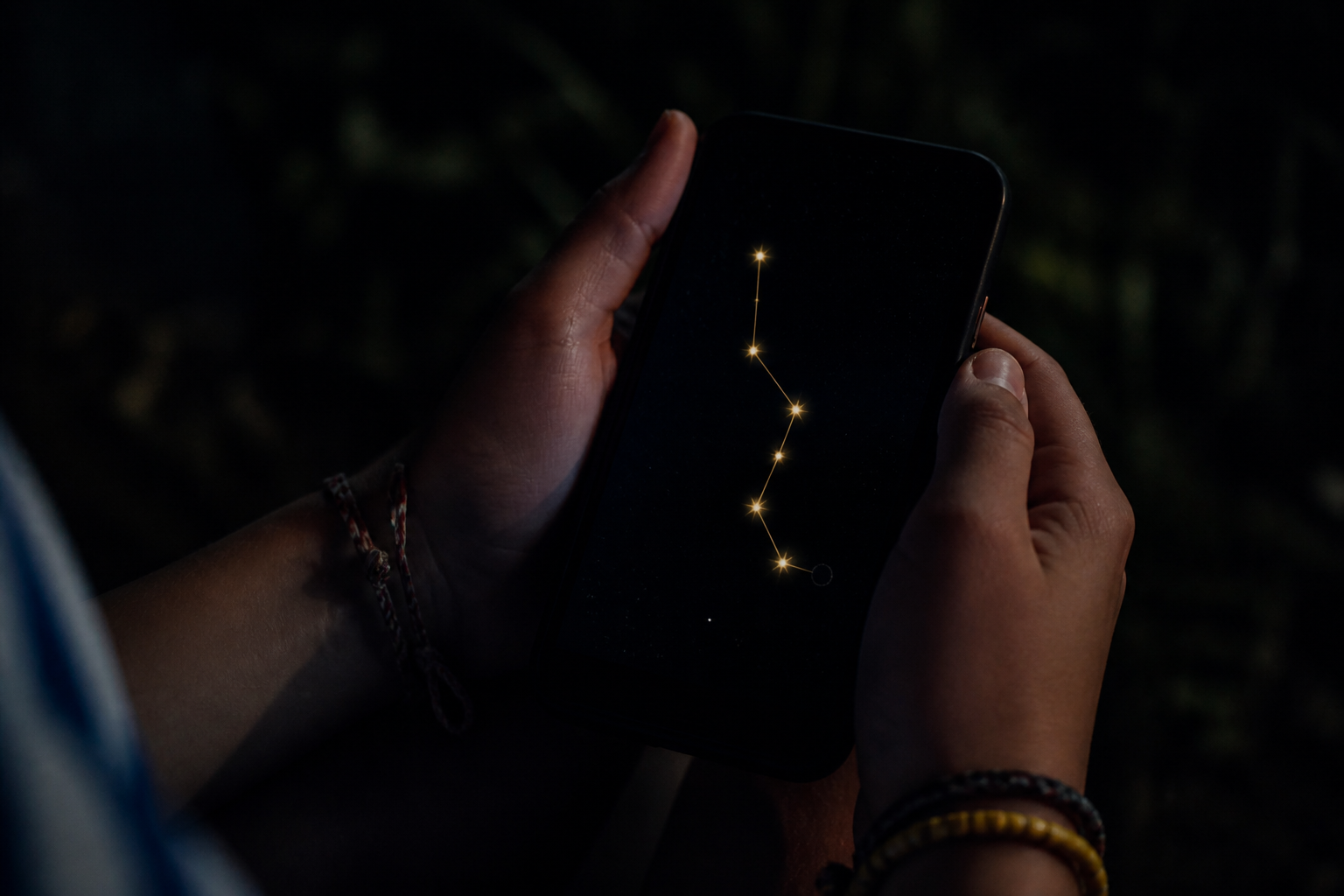 A phone in the dark showing six stars and an empty seventh point
